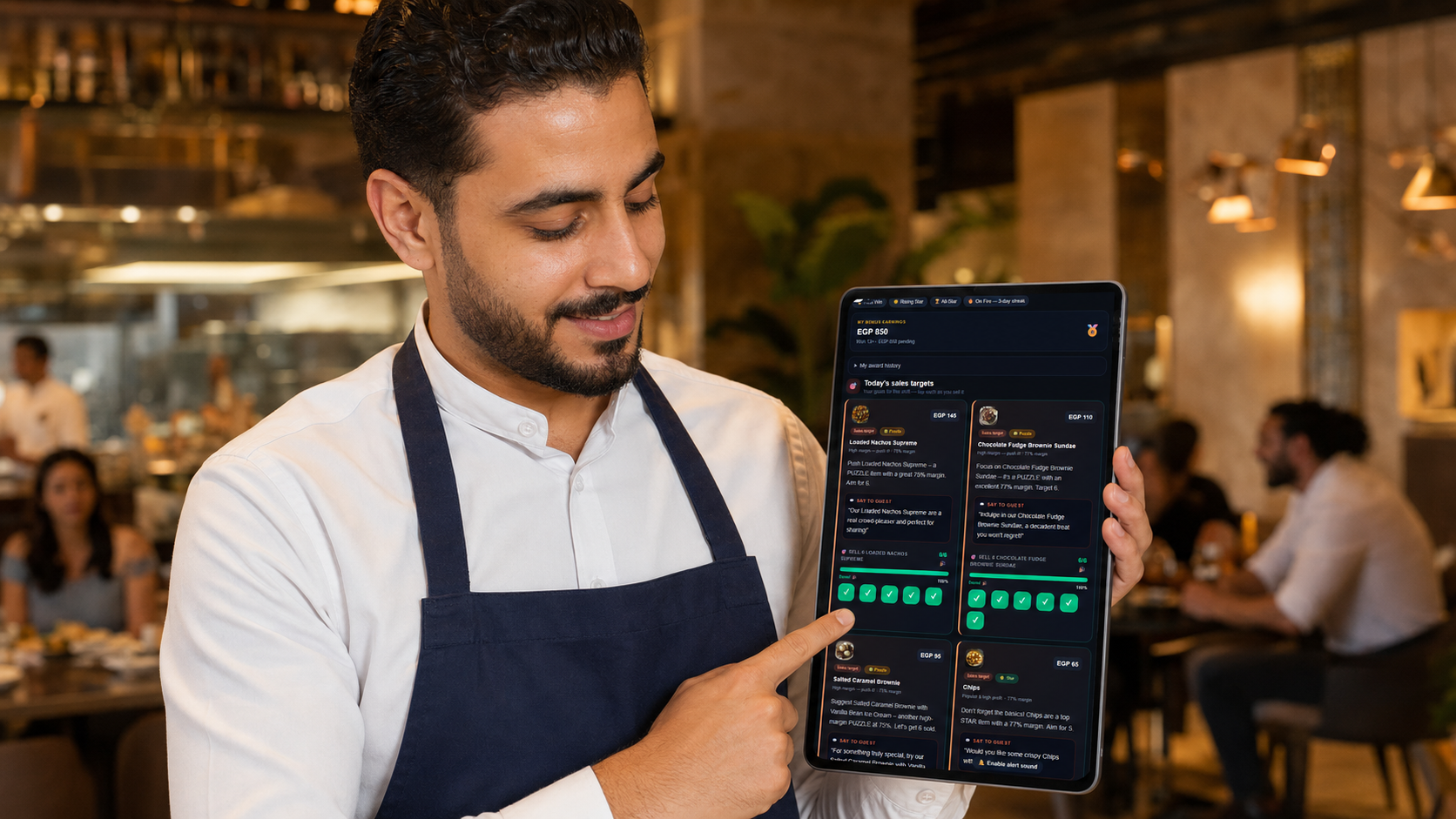 A waiter checks his daily sales targets and earned bonus on a tablet, with badges for streaks and top performance